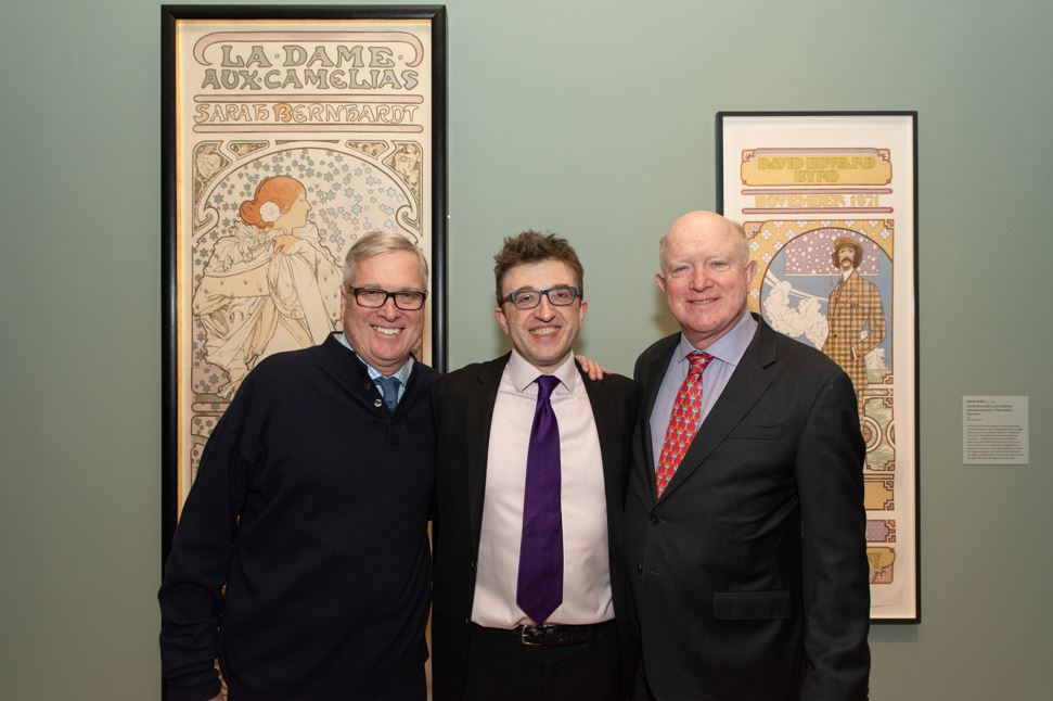 Photograph of Marcus Mucha and two of his cousins with Alphonse Mucha's artwork